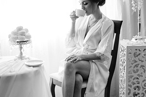 A young bride sits at a slot machine in the morning and drinks c
