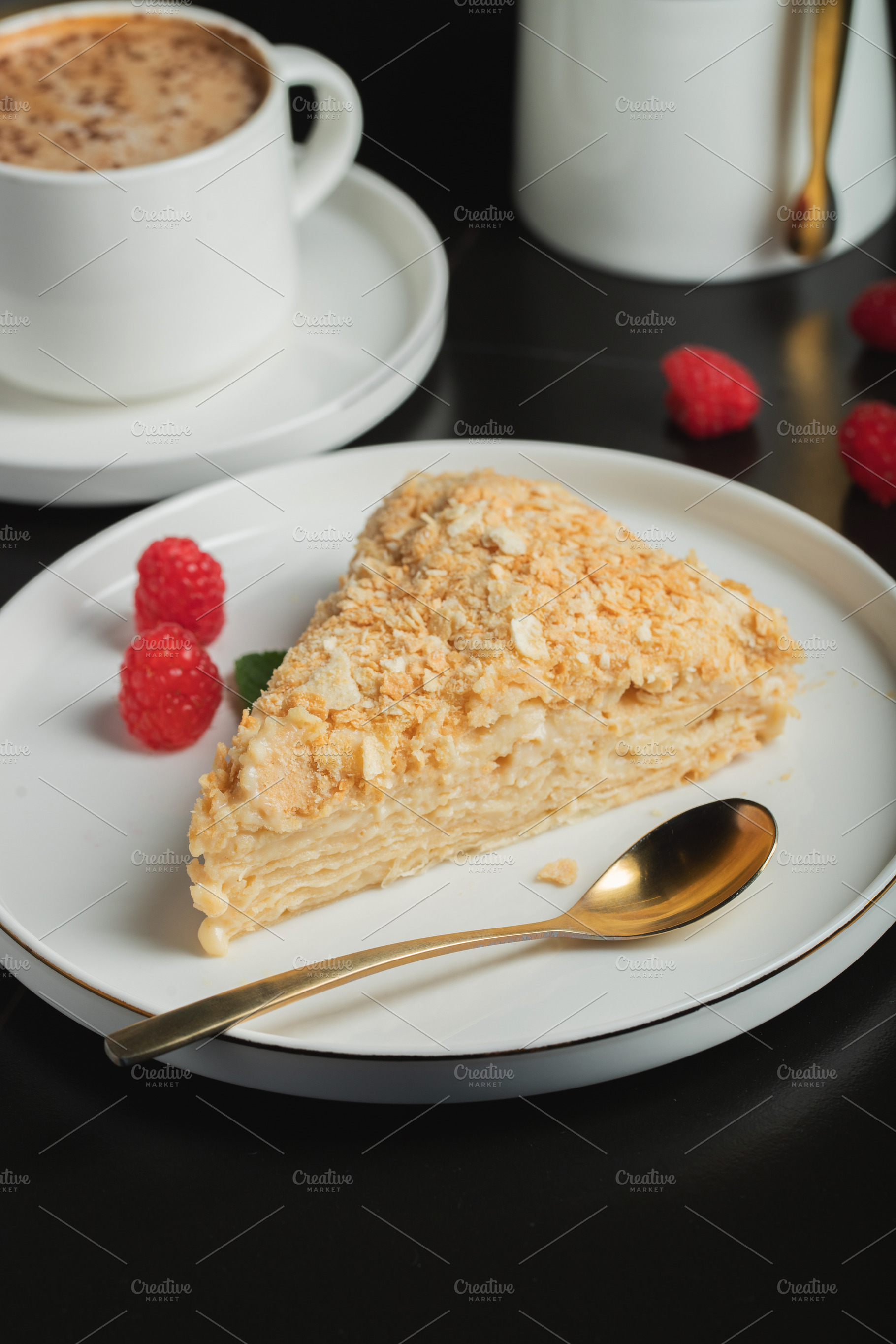 Sliced Napoleon cake on a white wooden table. Classic dessert, a Food & Drink Photo by Budarinphoto