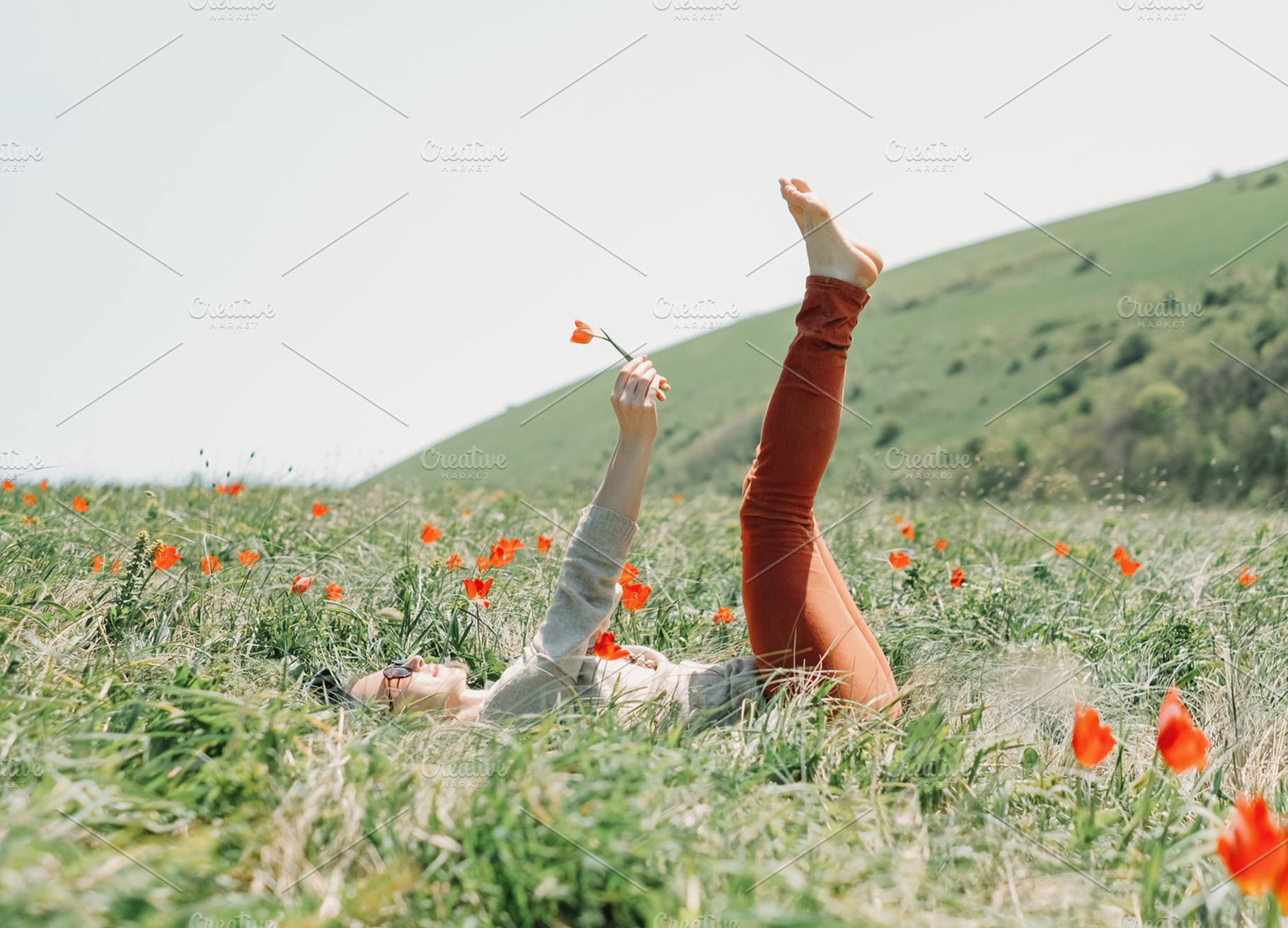 Woman relaxing on flower field., a Person Photo by P&G