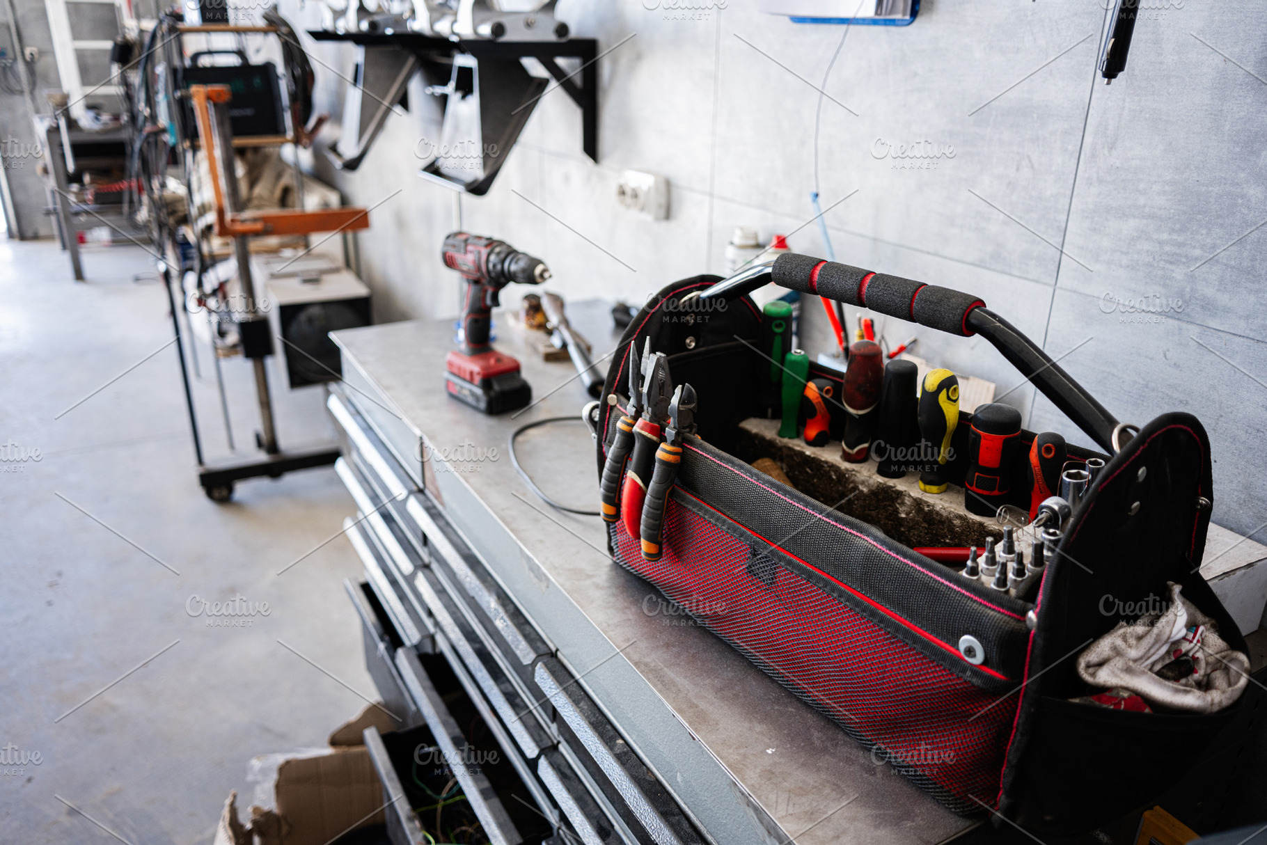 Toolbox with tools and equipment in a modern workshop on a workbench, a Photo by AS photostudio