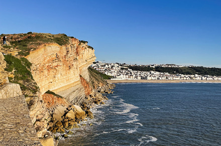 Scenic coastal cliffs and ocean in Nazare, Portugal under clear blue sky, a Photo by AS photostudio