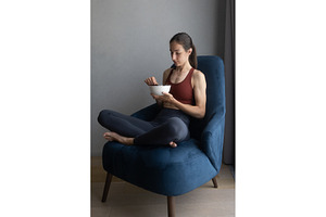 Woman sitting cross legged in a blue
