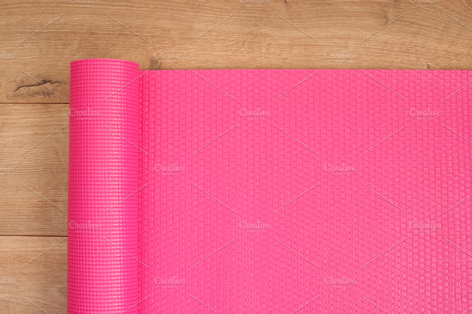 Pink yoga mat on a wooden background featuring yoga, mat, and background, a Sports & Recreation Photo by MONNKA