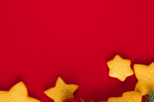 Christmas gingerbread cookies with red baubles and evergreen bra