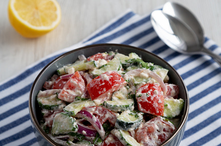Homemade Tomato Cucumber Feta Salad in a Bowl, side view., a Food & Drink Photo by LiudmylaChuhunova