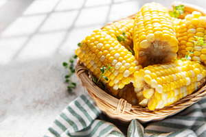 Fresh corn cobs in basket with morning light, a Food & Drink Photo by Olena Rudo