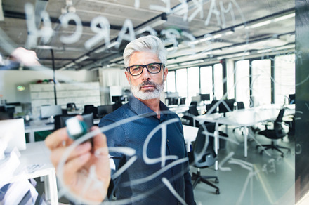Mature businessman with gray hair in the office featuring office, business, a Business Photo by HalfPoint