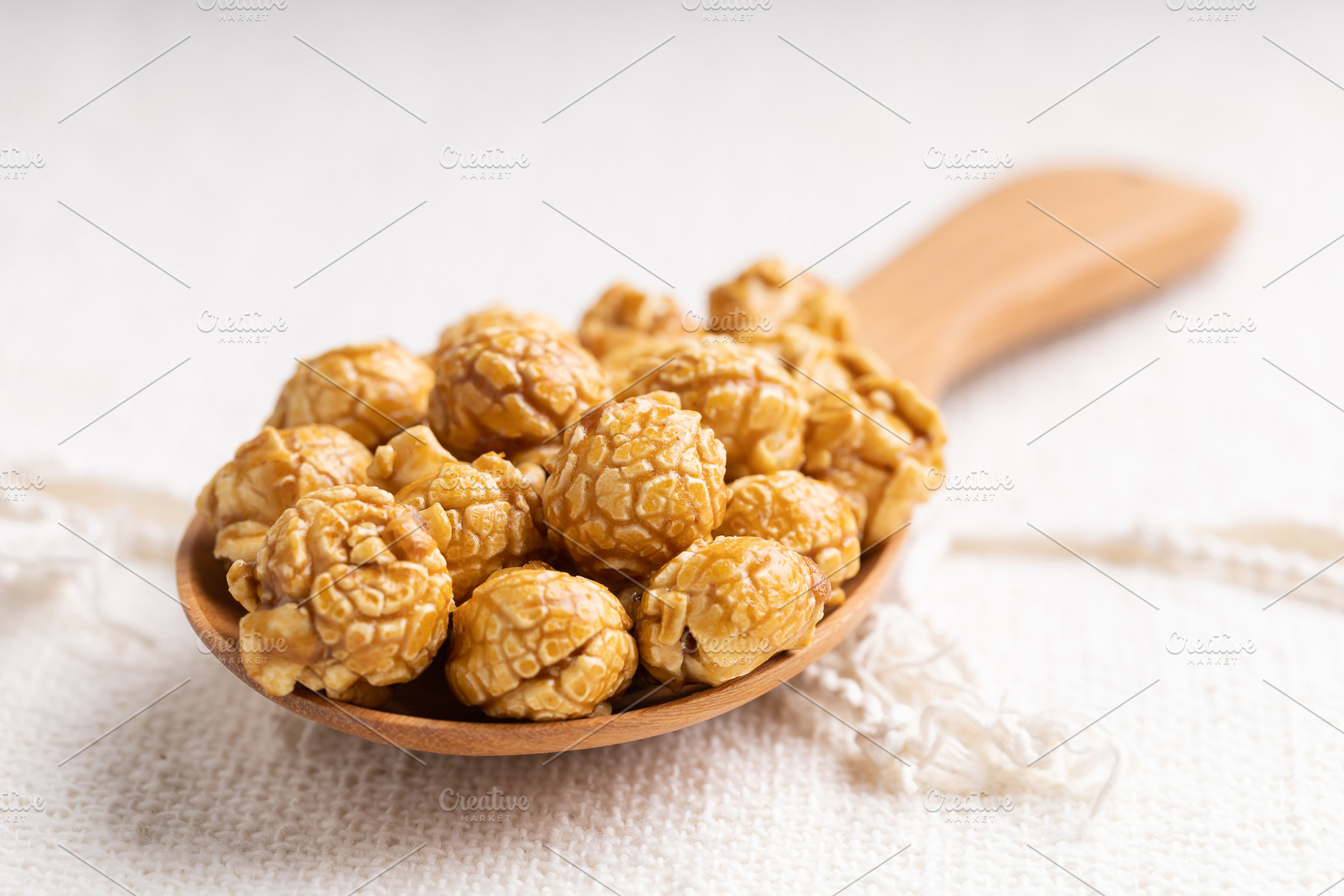 Caramel popcorn in wooden ladle, a Food & Drink Photo by Smith Chetanachan