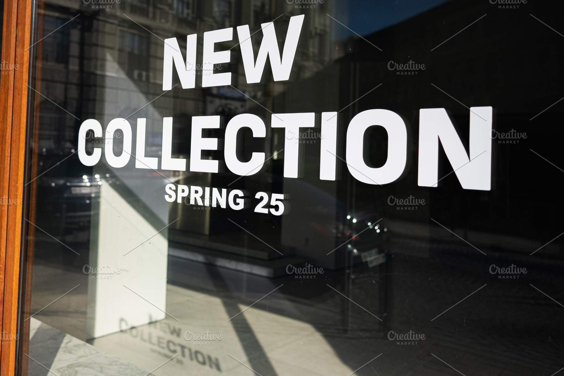 Modern storefront showcasing spring fashion 2025 with reflective city backgroun, a Photo by AS photostudio