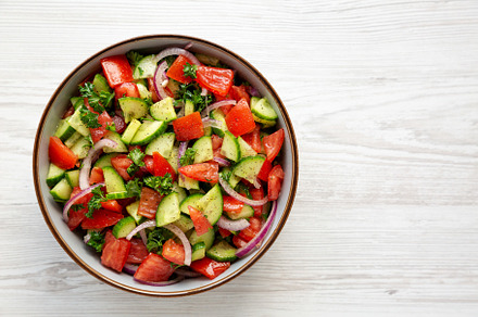 Homemade Mediterranean Cucumber Tomato Salad in a Bowl, top view, a Food & Drink Photo by LiudmylaChuhunova