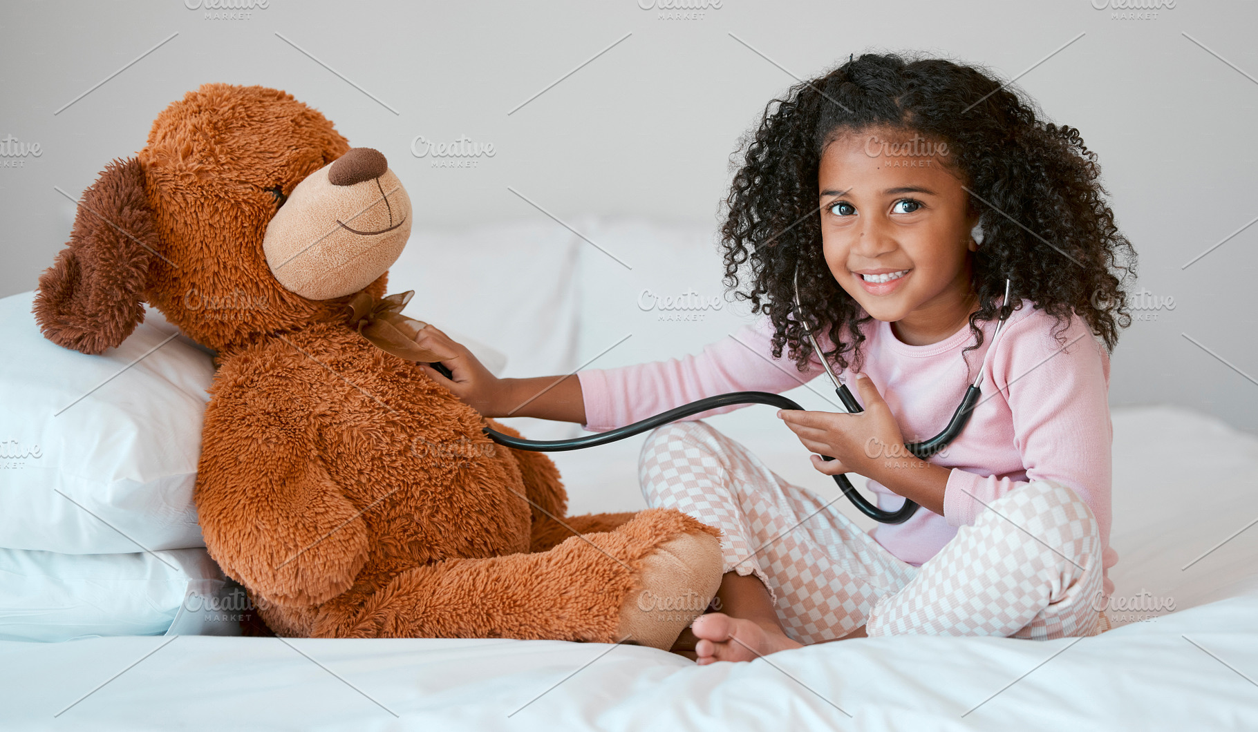 Learning, teddy bear and girl playing with stethoscope, having fun or acting like doctor in bedroom. Portrait, education and child test, check or listening to heartbeat of stuffed animal or baby toy., a Photo by Peopleimages.com