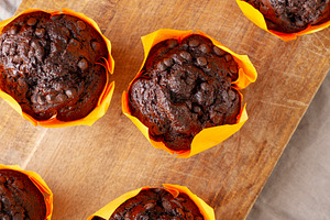 Homemade Chocolate Chip Muffins on a wooden board, top view., a Food & Drink Photo by LiudmylaChuhunova