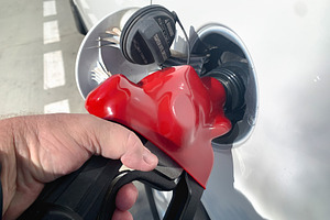 Male Hand Holding Gas Pump Nozzle, a Transportation Photo by Andy Dean Photography