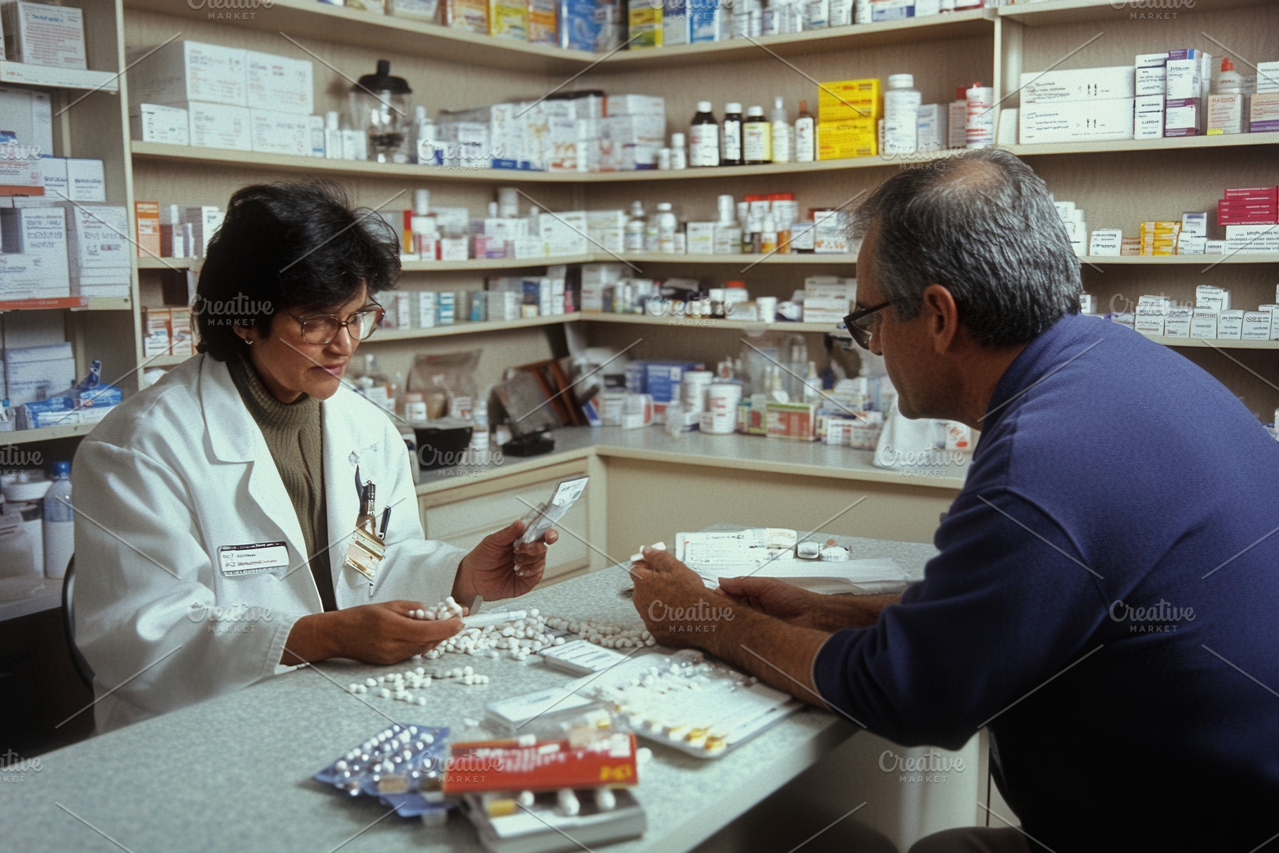 Pharmacist consulting with a patient, a Photo by Pavel_design