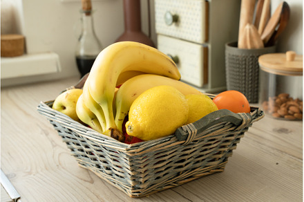 Basket with fresh fruits on table in, a Food & Drink Photo by oksix
