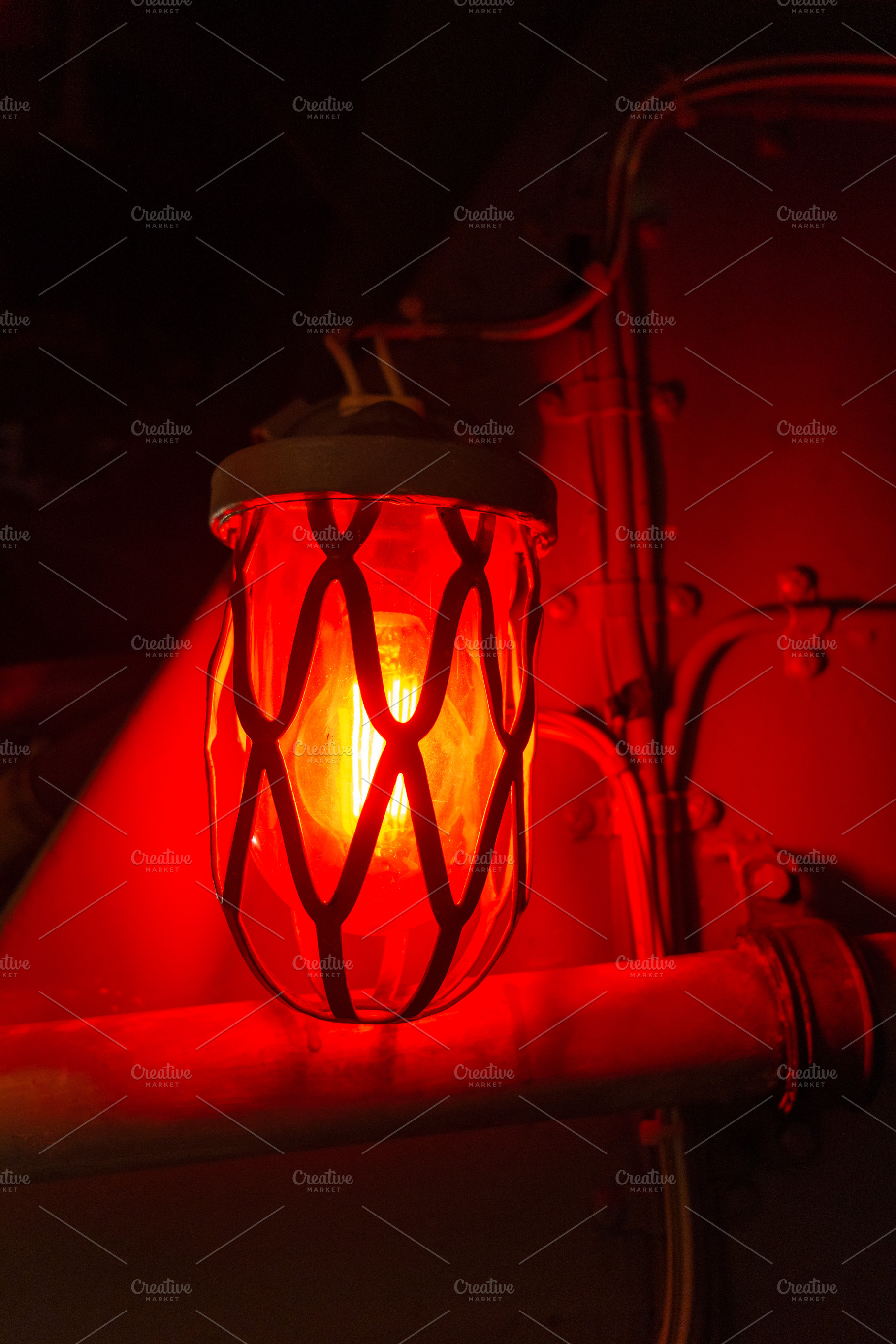 Red alarm light inside an old military submarine with protective, a Transportation Photo by GoodGoods