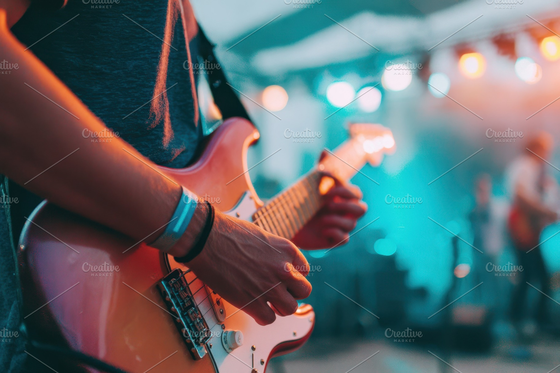 Guitarist playing electric guitar on stage, an Arts & Entertainment Photo by AlyaAnd