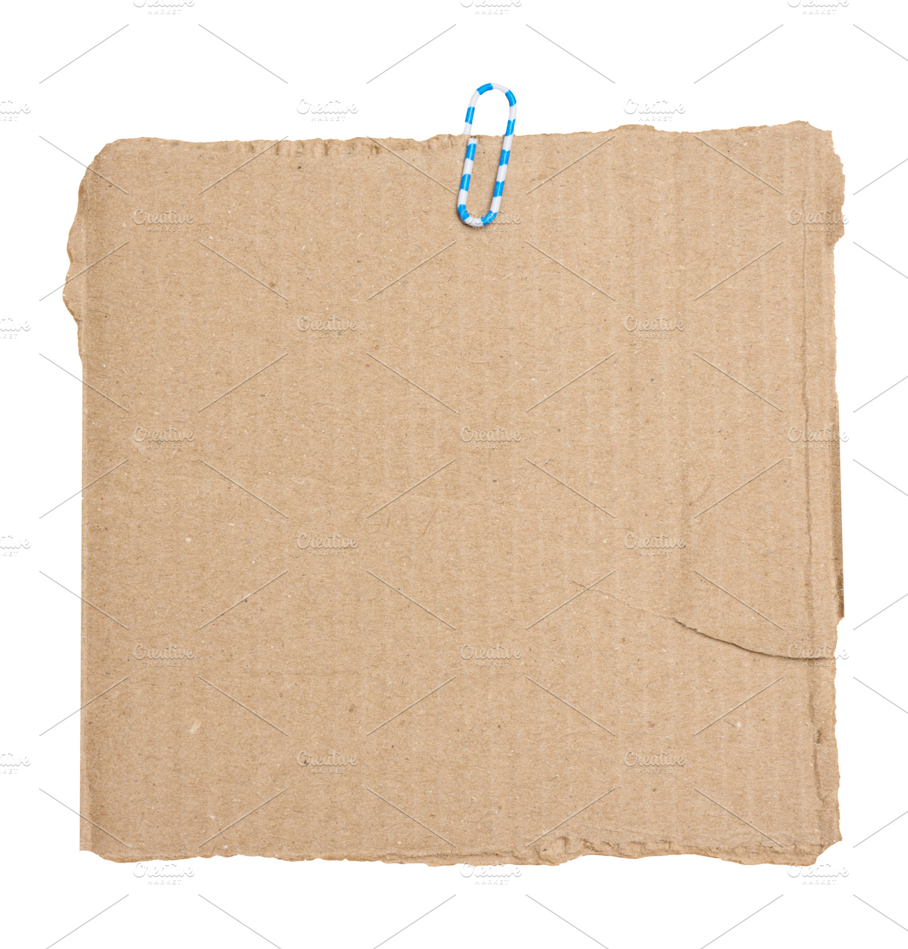 A torn piece of brown cardboard with a blue and white paper clip, a Background Photo by ndanko