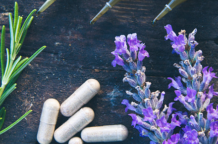 Natural medicine in ampules and pills on wooden background featuring medical