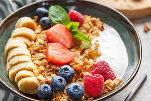 Delicious granola with yogurt, fresh berries and banana slices e, a Food & Drink Photo by Olena Rudo