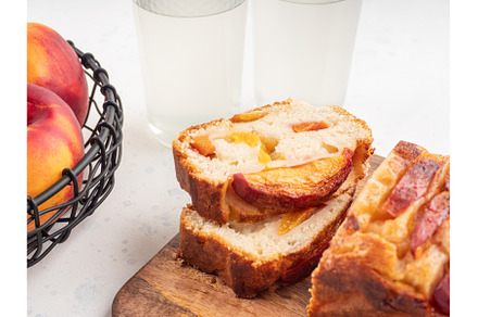 Peach cake loaf on wooden cutting