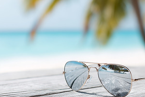 Aviator sunglasses resting on table, a Nature Photo by MistyDay