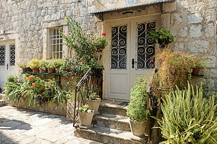 Gardening outside near stone buildin, an Architecture Photo by Photo by YuraYaryna