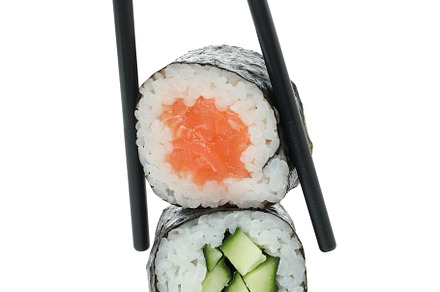Chopsticks with maki isolated on white background, a Food & Drink Photo by AtlasStudio