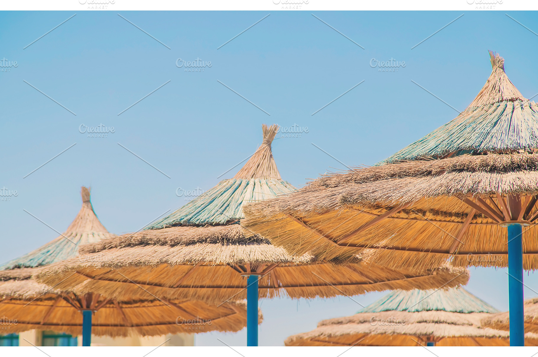Thatched umbrellas on the beach, a Nature Photo by yanadjana