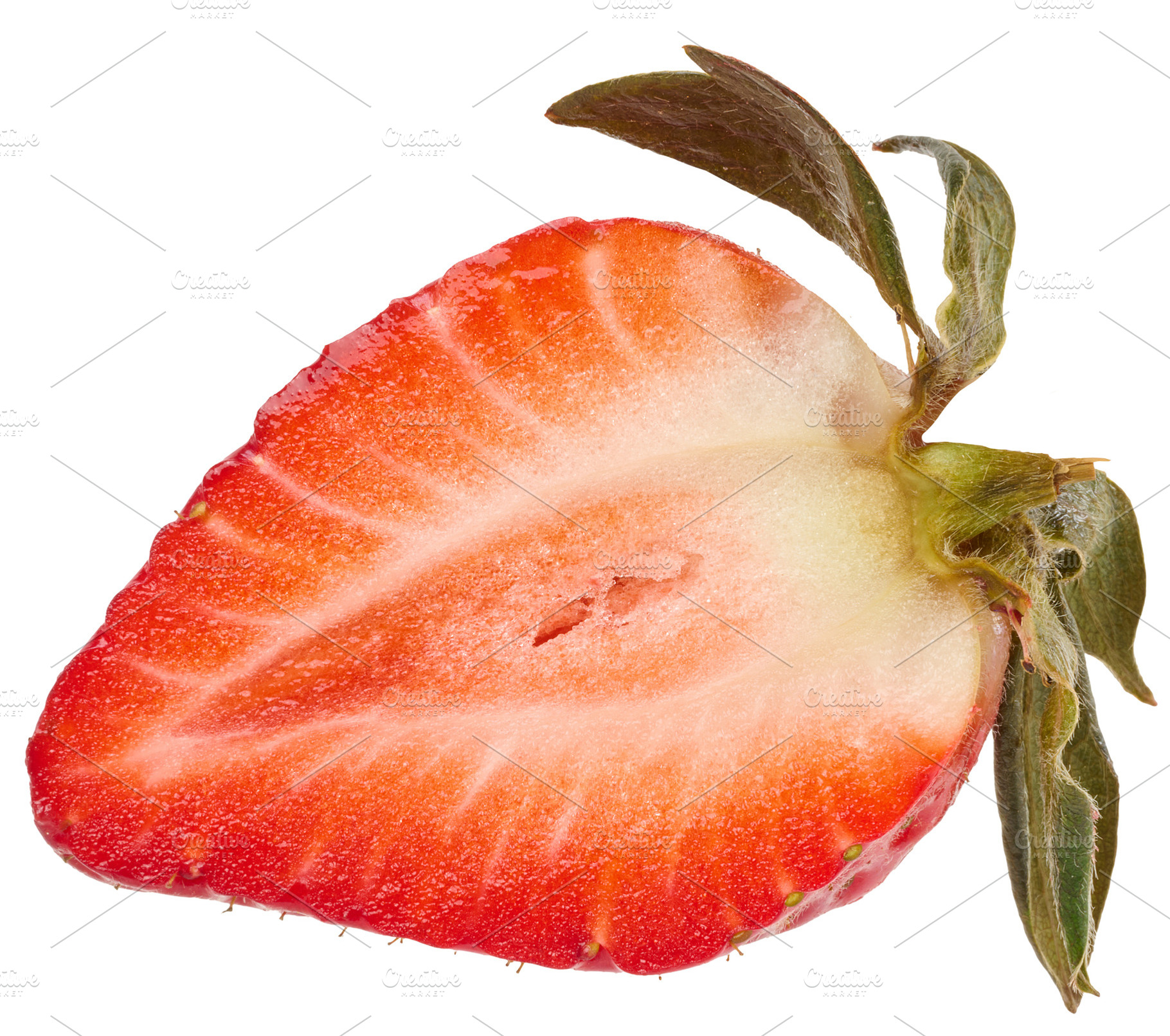 Longitudinal section of ripe strawberry with green leaves on an, a Food & Drink Photo by ndanko