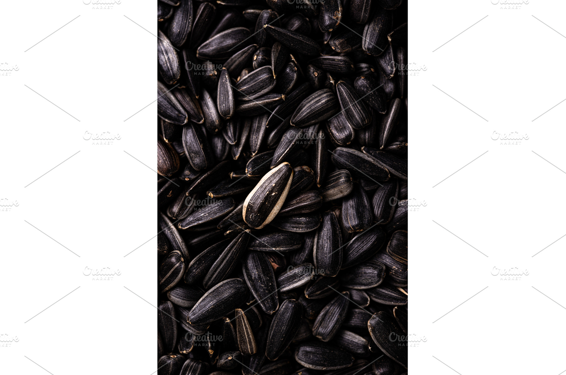Black sunflower seeds texture close, a Food & Drink Photo by Yulia Furman