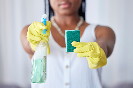 Hands, spray bottle and sponge with a black woman cleaner in a home for housework, hygiene or cleaning. Gloves, spraying and equipment with a female maid in a house for domestic housekeeping, a Photo by Peopleimages.com