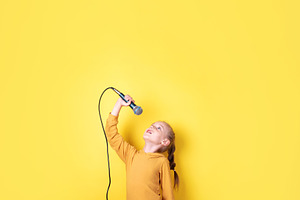 Happy Girl Singing with Microphone, a Person Photo by Ales Munt
