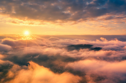 Aerial view of mountains in orange clouds at sunrise in summer, a Nature Photo by den-belitsky