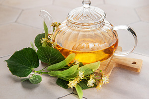 Linden tea brewing in glass teapot with herbs, a Food & Drink Photo by Olena Rudo