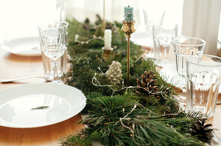 Christmas table setting. Rosemary branch on plate, cutlery, cand, a Holiday Photo by Sonjachni