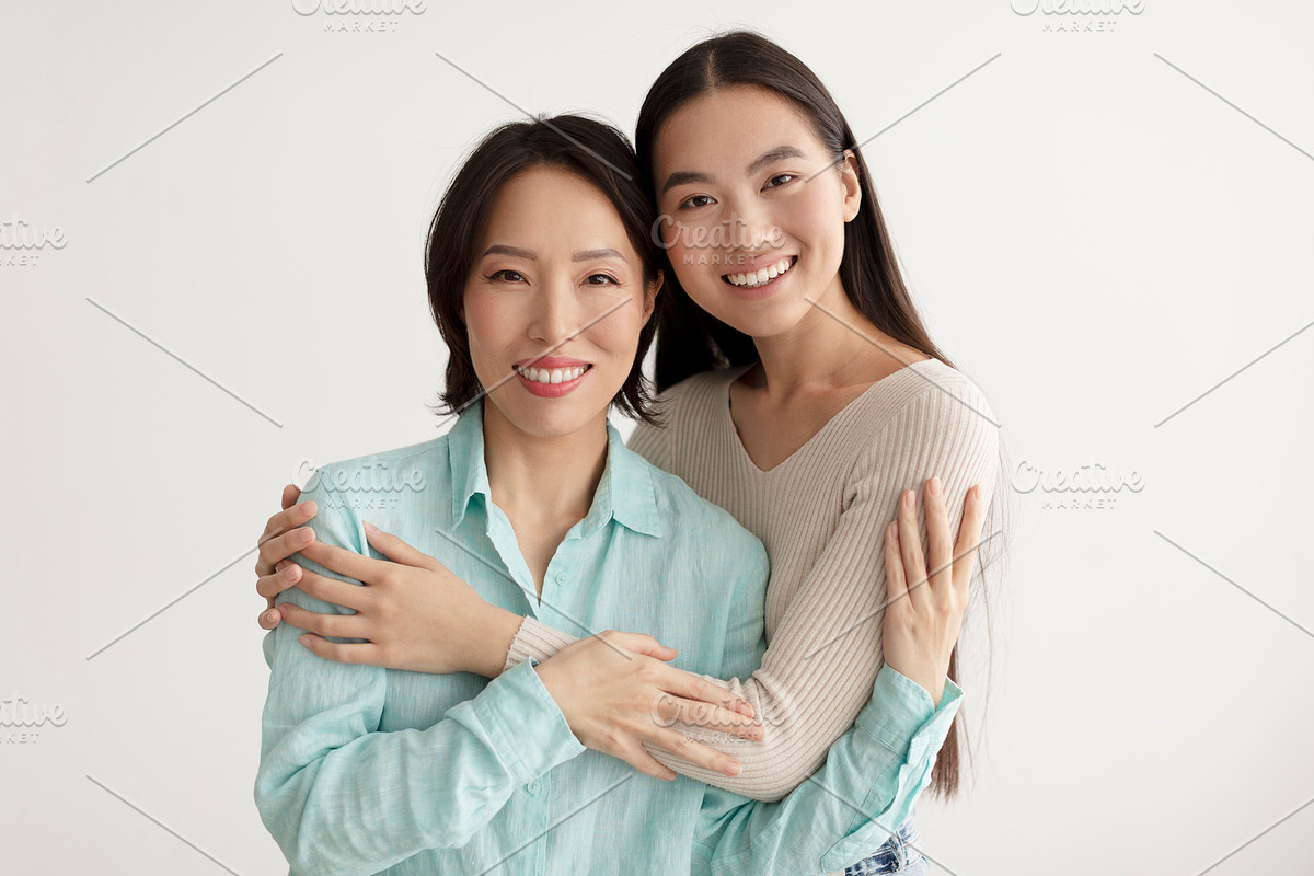 Joyful young Asian woman and her senior mother hugging and smiling at camera on, a Photo by Prostock-Studio (Photo 2 of 3)