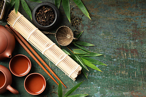 Japanese Tea Ceremony Elements with Teaware and Bamboo Mat on Ru