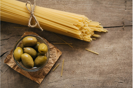 Long yellow raw spaghetti and green, a Food & Drink Photo by olhovyi_photographer