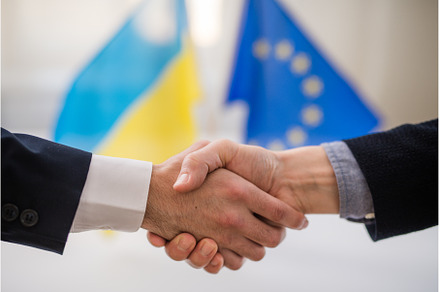 Handshake between the European Union, a Business Photo by HalfPoint