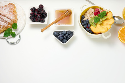 plate with oatmeal and fruit, half a ripe orange and freshly squ, a Food & Drink Photo by ndanko