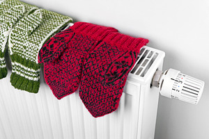 Wool knitted mittens on radiator, a Beauty & Fashion Photo by BOOCYS