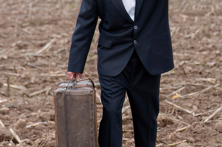 emigrant with suitcase and vintage suit leaving his village to l
