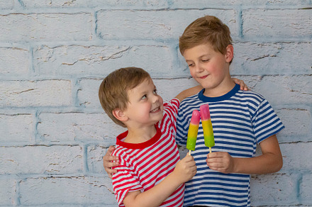Two happy smiling boys are eating, a Person Photo by Anno Urbis