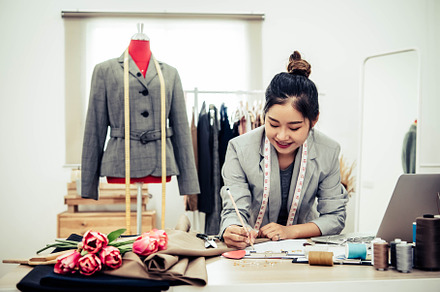 Attractive Asian female fashion designer  working in home office, a Beauty & Fashion Photo by Ministocker
