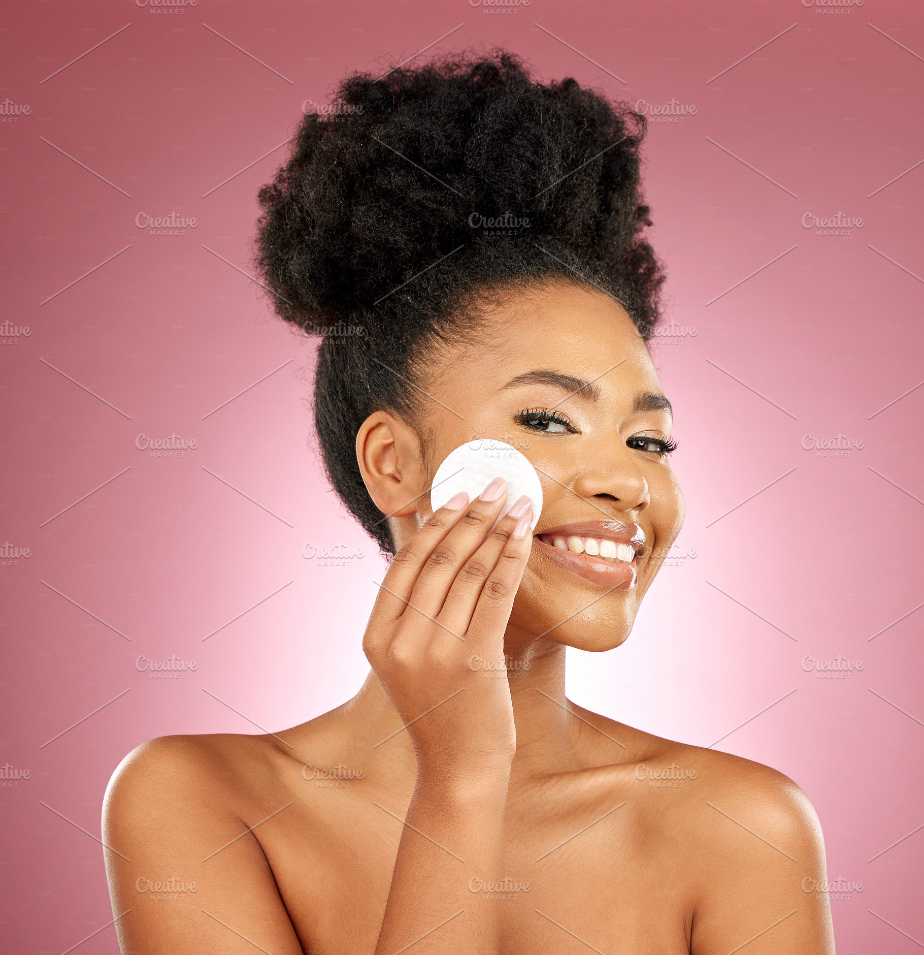Black woman, cotton pad and skincare with makeup, portrait and facial on a studio background. Female person, face and happy model with cosmetics, aesthetic and cleaning with patches, shine and glow, a Photo by Peopleimages.com