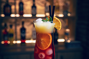 Refreshing cocktail garnished with mint and orange slices, a Photo by Grafvision photography