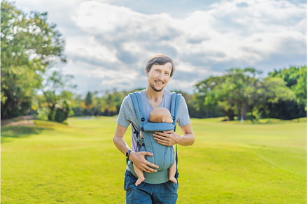 Young father walks in nature with