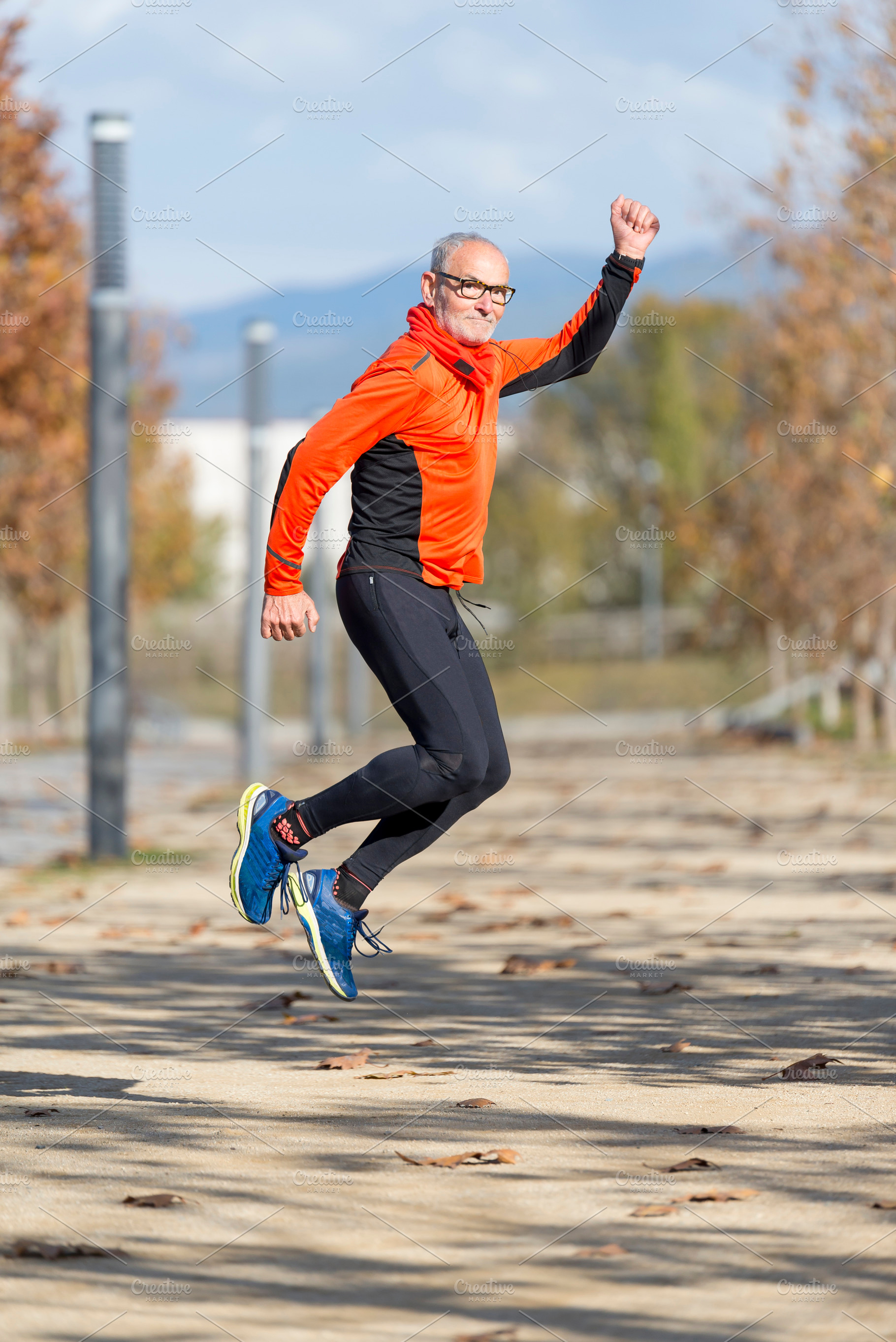 Senior man jumping high outdoors, showing energy and joy, a Sports & Recreation Photo by RF Images