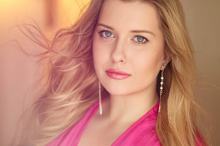 Woman with blue eyes and long, voluminous blonde hair styled in, a Person Photo by Anneleven